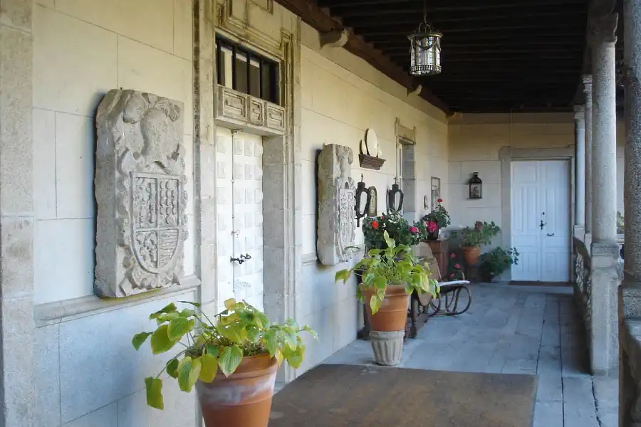 Close-up of a carved heraldic coat of arms on the granite facade