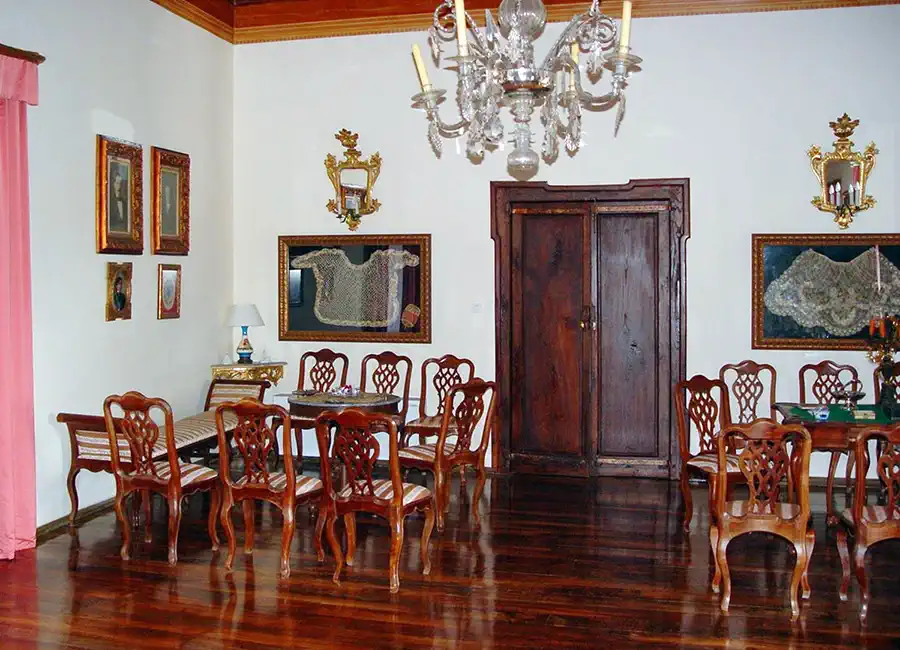 A formal reception room with period furniture and high ceilings