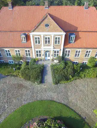 Historic renovated manor house from 1768 with moat near the Baltic Sea and Denmark, Schleswig-Holstein